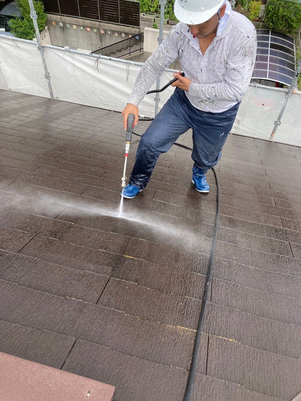 生駒市の屋根塗装現場で屋根の洗浄作業