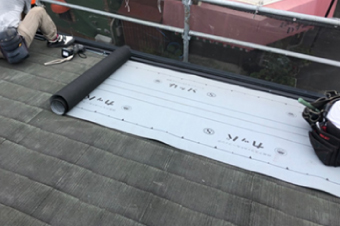 既存のスレート屋根の上に新しい防水紙を敷設